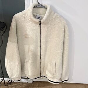 Umbro Cream Fleece Jacket with Black Accents . Has pockets